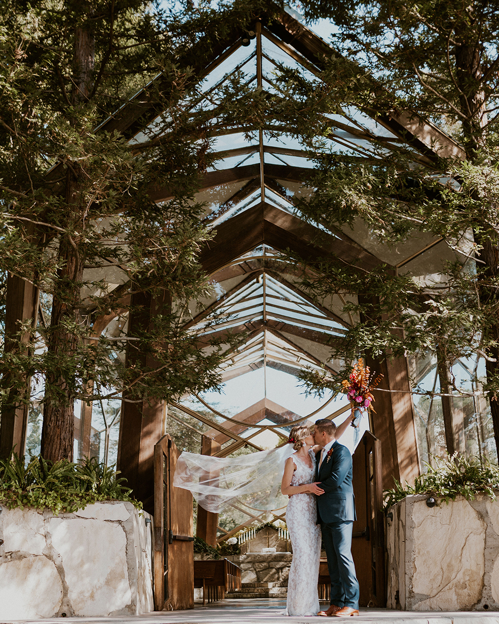 bride and groom kissing wayfarers chapel