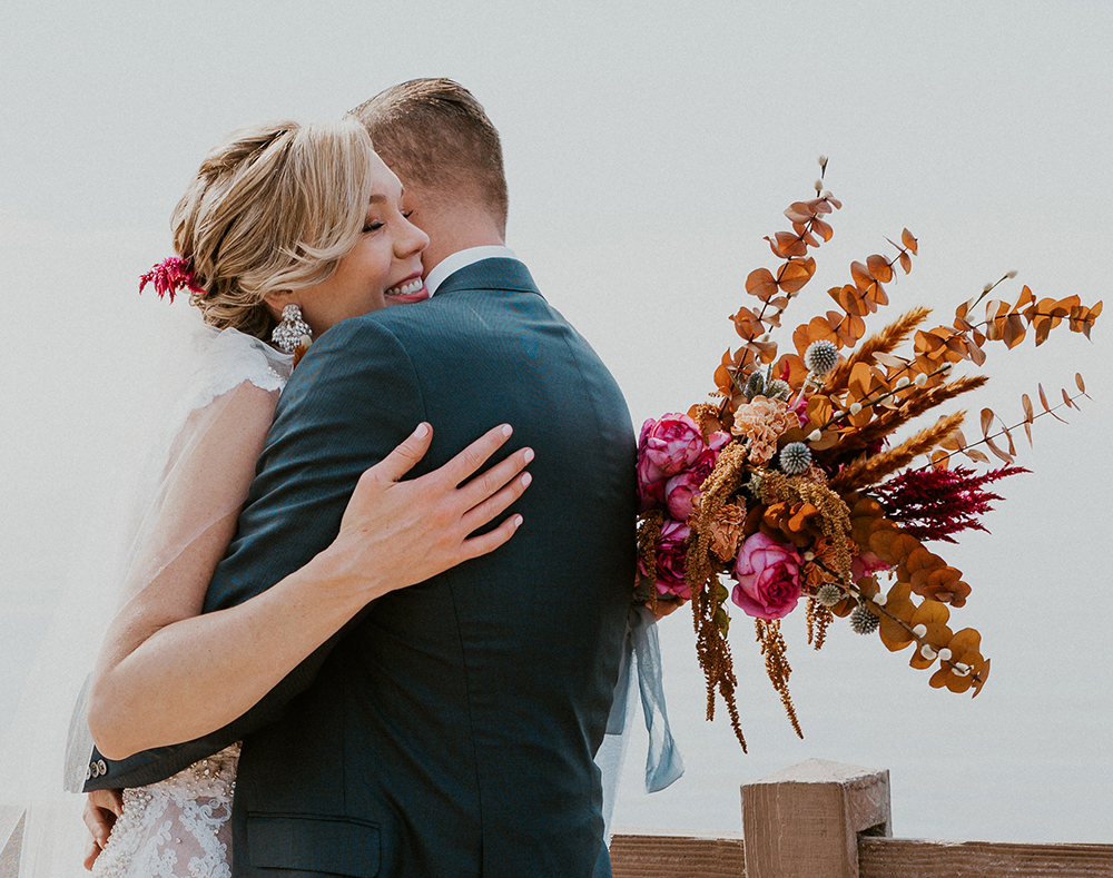bride and groom embrace with bouquet palos verdes