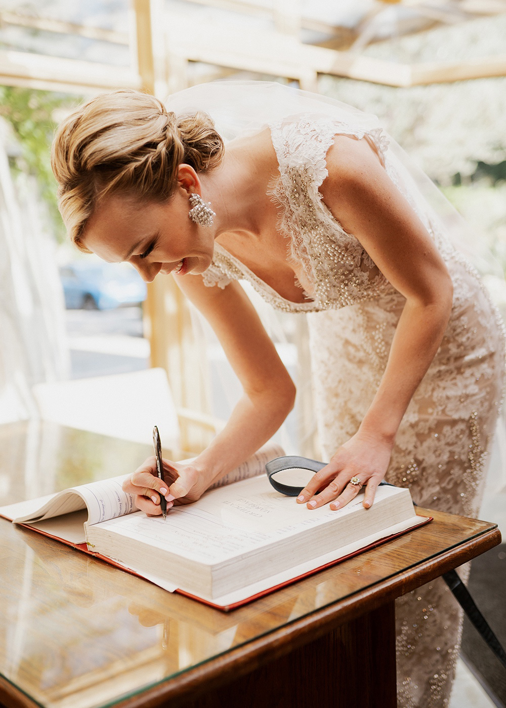 bride signing wedding certificate