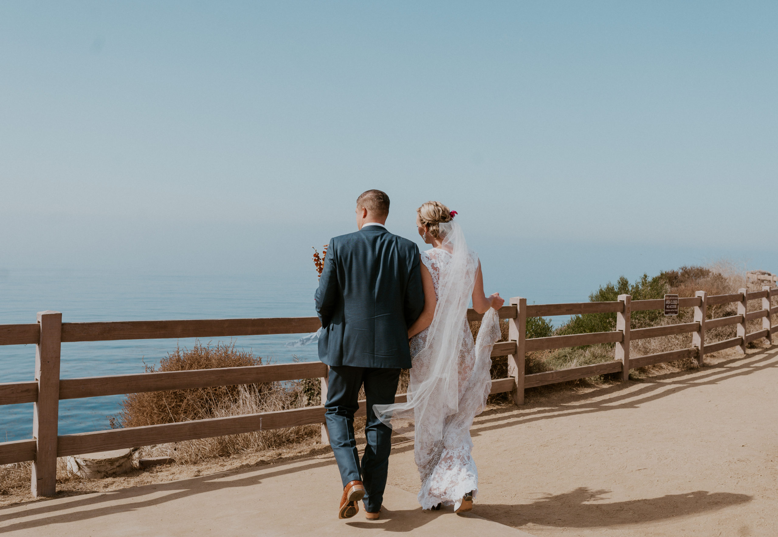 bride and groom by pacific ocean